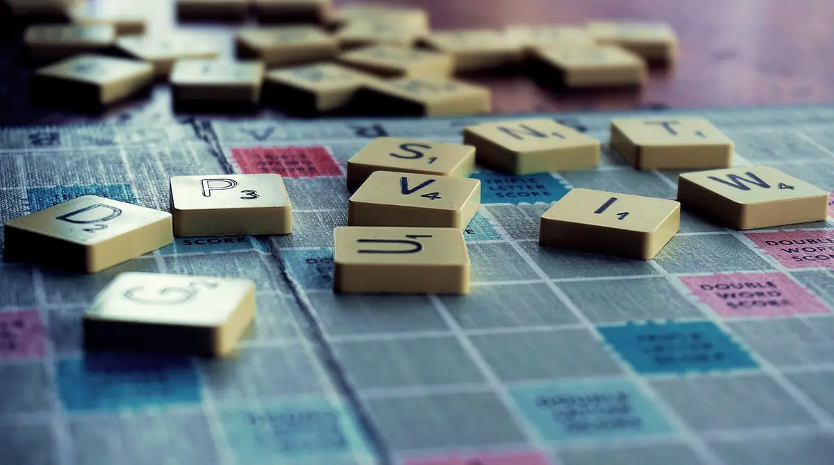Letter tiles scattered on a word game board